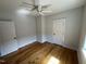 Bright bedroom featuring wood floors, neutral paint, and two doors at 65 Oglethorpe Ave, Clayton, NC 27527