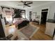 Inviting bedroom with floral wallpaper, hardwood floors, decorative rug, and a king-size bed at 65 Oglethorpe Ave, Clayton, NC 27527