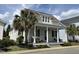 Inviting two-story home with a covered porch, swing, and a meticulously landscaped front yard at 65 Oglethorpe Ave, Clayton, NC 27527