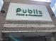 Exterior of a Publix grocery store with recognizable green signage against a brick and white facade at 65 Oglethorpe Ave, Clayton, NC 27527