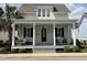 Charming two-story home with a welcoming front porch, swing, and lush landscaping at 65 Oglethorpe Ave, Clayton, NC 27527
