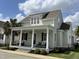 Charming two-story home with a front porch swing on a sunny day at 65 Oglethorpe Ave, Clayton, NC 27527