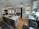 Open-concept kitchen with an island, stainless steel appliances, and adjacent dining and living areas at 65 Oglethorpe Ave, Clayton, NC 27527
