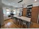 Bright kitchen features a large island with seating, stainless steel appliances, and rustic wood accents at 65 Oglethorpe Ave, Clayton, NC 27527
