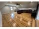 Spacious living room with hardwood floors and neutral walls features a large brown leather sectional sofa at 65 Oglethorpe Ave, Clayton, NC 27527