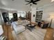 Open-concept living room with hardwood floors, modern furnishings, and a view of the kitchen at 65 Oglethorpe Ave, Clayton, NC 27527