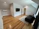 Spacious living room with hardwood floors and neutral walls features a comfortable black leather recliner at 65 Oglethorpe Ave, Clayton, NC 27527