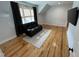 Spacious living room with hardwood floors and neutral walls features a comfortable black leather recliner at 65 Oglethorpe Ave, Clayton, NC 27527