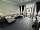 Inviting outdoor porch with a large sofa, throw pillows, and black curtains at 65 Oglethorpe Ave, Clayton, NC 27527