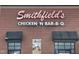 Close-up of Smithfield's Chicken 'N Bar-B-Q restaurant exterior showing sign and awnings at 65 Oglethorpe Ave, Clayton, NC 27527