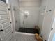 Sleek glass enclosed shower with white subway tile and a dark tiled floor at 65 Oglethorpe Ave, Clayton, NC 27527
