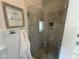 Modern tiled shower with glass enclosure, rainfall showerhead, and built-in shelving at 65 Oglethorpe Ave, Clayton, NC 27527