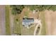 An aerial view shows this house situated on a large lot with mature trees and surrounding fields at 664 Marler Rd, Benson, NC 27504