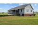 Lawn view of a home featuring a screened-in porch and brick foundation accents at 664 Marler Rd, Benson, NC 27504