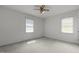 White bedroom featuring a ceiling fan and 2 windows at 664 Marler Rd, Benson, NC 27504