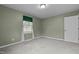 A cozy carpeted bedroom with a window bringing in natural light and freshly painted walls at 664 Marler Rd, Benson, NC 27504