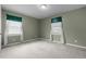 A carpeted bedroom featuring light walls, two windows, and neutral colors at 664 Marler Rd, Benson, NC 27504