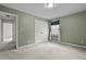 A spacious carpeted bedroom featuring a double door closet and a window at 664 Marler Rd, Benson, NC 27504