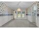 Formal dining room with floral wallpaper and access to the backyard at 664 Marler Rd, Benson, NC 27504