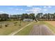 A charming one-story home with a long drive, surrounded by agricultural fields and mature trees at 664 Marler Rd, Benson, NC 27504
