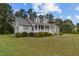 Charming single-story house with a side porch, complemented by a well-manicured lawn at 664 Marler Rd, Benson, NC 27504