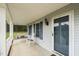 Inviting front porch with a swing, rocking chair, and a view of the surrounding trees at 664 Marler Rd, Benson, NC 27504