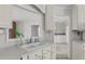 Bright eat-in kitchen sink area featuring white cabinets and a view of the living room at 664 Marler Rd, Benson, NC 27504