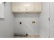 A small laundry room with overhead cabinets and utility hookups at 664 Marler Rd, Benson, NC 27504