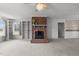 Bright and open living room featuring a brick fireplace and built-in shelves at 664 Marler Rd, Benson, NC 27504