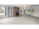 Spacious living room with a brick fireplace, built in shelving, floral wallpaper, and access to the sunroom at 664 Marler Rd, Benson, NC 27504