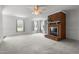 Large living room with brick fireplace, built-in shelves and multiple windows filling the space with natural light at 664 Marler Rd, Benson, NC 27504