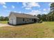 View of the house from the rear, highlighting the screened-in porch and attached garage at 664 Marler Rd, Benson, NC 27504