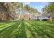 Expansive backyard with lush green grass, complemented by a spacious deck and mature trees for privacy at 707 Sinai Cir, Hillsborough, NC 27278