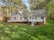 Aerial view of a sprawling backyard with a deck and a shed, all surrounded by lush greenery and mature trees at 707 Sinai Cir, Hillsborough, NC 27278