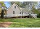 Expansive backyard features a raised deck with white railings and stairs, perfect for outdoor entertaining at 707 Sinai Cir, Hillsborough, NC 27278