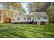 Spacious backyard showing the elevated deck of the house with wheelchair access and an additional shed on the property at 707 Sinai Cir, Hillsborough, NC 27278