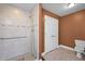 Bathroom features a tiled walk-in shower with safety bars and a nearby toilet at 707 Sinai Cir, Hillsborough, NC 27278