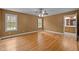 Cozy bedroom with hardwood floors, two windows, and a ceiling fan at 707 Sinai Cir, Hillsborough, NC 27278