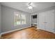 This bedroom has neutral walls, hardwood floors, and a window overlooking the backyard at 707 Sinai Cir, Hillsborough, NC 27278