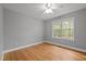 The bedroom has hardwood floors, neutral walls, and a window with natural light at 707 Sinai Cir, Hillsborough, NC 27278