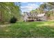 Charming two-story home features a welcoming front porch, lush lawn, and mature trees at 707 Sinai Cir, Hillsborough, NC 27278