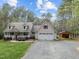Well-maintained home boasting a spacious front yard, a front porch, and a convenient two-car garage with an attached shed at 707 Sinai Cir, Hillsborough, NC 27278