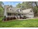 Beautiful two-story home boasts a covered front porch, attached garage, manicured landscaping, and a well-kept lawn at 707 Sinai Cir, Hillsborough, NC 27278