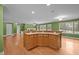 Open-concept living room with hardwood floors, a kitchen island, and ample natural light at 707 Sinai Cir, Hillsborough, NC 27278