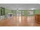 Spacious living room with hardwood floors, a fireplace, and multiple windows providing natural light and scenic views at 707 Sinai Cir, Hillsborough, NC 27278