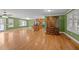 Spacious living room featuring hardwood floors, green walls, and natural light from large windows at 707 Sinai Cir, Hillsborough, NC 27278