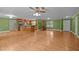 Open-concept living space with hardwood floors, kitchen island, stainless steel appliances, and ample room for entertaining at 707 Sinai Cir, Hillsborough, NC 27278