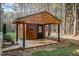 Charming wood shed with a covered porch offers ample storage or a workshop space in a secluded backyard setting at 707 Sinai Cir, Hillsborough, NC 27278