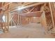 A spacious unfinished attic with wooden beams and subflooring, offering potential for customization at 707 Sinai Cir, Hillsborough, NC 27278