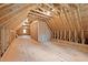 Unfinished attic space with natural wood flooring and ample room to expand at 707 Sinai Cir, Hillsborough, NC 27278